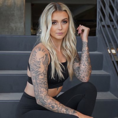 A photo of Mackenzie Smith with tattoos and fitness clothes